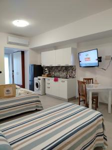 a living room with two beds and a kitchen at B&B Gattopardo in Cariati
