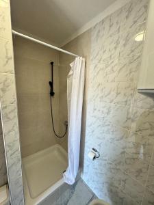 a bathroom with a shower with a shower curtain at Apartment Niko in Pakoštane