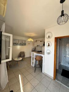 a kitchen and living room with a table and chairs at Apartment Niko in Pakoštane