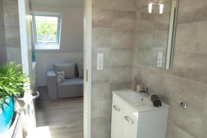 a bathroom with a sink and a mirror at Kardos Villa in Szigliget +30 photos