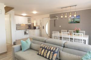 a living room with a couch and a kitchen at Kardos Villa in Szigliget