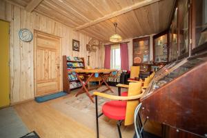 a room with a table and chairs and a dining room at Kuberi Retro Holiday Home I Sauna Possibility in Pedja