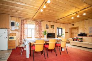 a kitchen and living room with a table and chairs at Kuberi Retro Holiday Home I Sauna Possibility in Pedja
