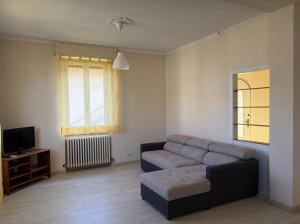 a living room with a couch and a tv at Ca' Sonenga in Menaggio
