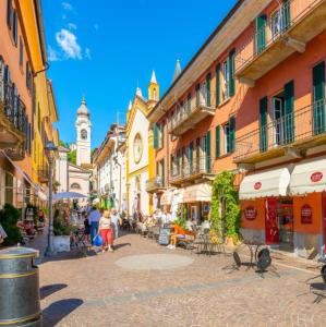 a group of people walking down a street with buildings at Ca' Sonenga in Menaggio