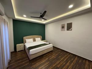 a bedroom with a bed and a ceiling fan at Executive 2 bedrooms in Rawalpindi - Self Checkin in Rawalpindi