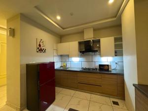 a kitchen with a red refrigerator in a room at Executive 2 bedrooms in Rawalpindi - Self Checkin in Rawalpindi +11 photos