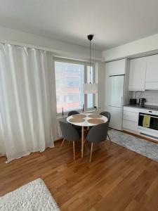 a kitchen with a table and chairs in a room at Lapland home in Rovaniemi