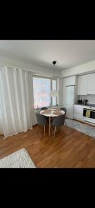a kitchen with a table and chairs in a room at Lapland home in Rovaniemi +4 photos