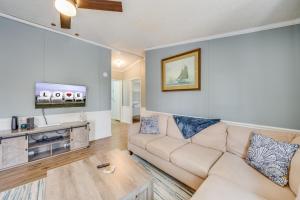 a living room with a couch and a flat screen tv at Bayside Haven in Deep Hole