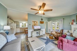a living room with a couch and a ceiling fan at Bayside Haven in Deep Hole