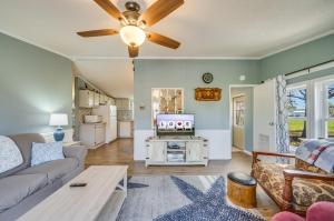 a living room with a couch and a ceiling fan at Bayside Haven in Deep Hole +33 photos