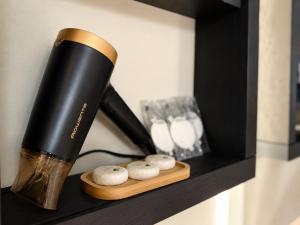 a black and gold flashlight sitting on a shelf at Tatry Premium Apartment - PRIVATE Parking in Kežmarok
