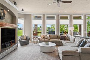 a living room with a couch and a fireplace at Mulligan Manor Golf Course Views Fun Amenities in Omaha