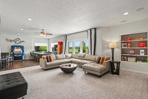 a living room with a couch and a table at Mulligan Manor Golf Course Views Fun Amenities in Omaha