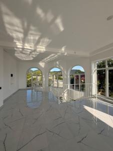 an empty room with marble floors and windows at Gabala Palm Villa in Gabala +43 photos