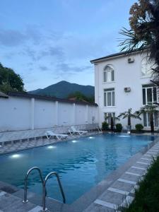 a building with a swimming pool next to a building at Gabala Palm Villa in Gabala