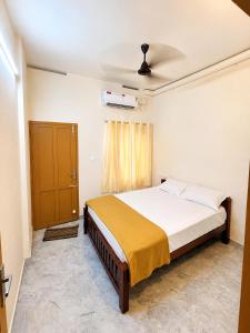 a bedroom with a large bed in a room at Sree Madhavam Stays AC Family Homestay Near Padmanabhaswamy Temple in Trivandrum