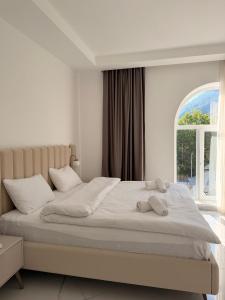 a bedroom with a large bed with a window at Gabala Palm Villa in Gabala