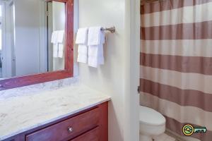 a bathroom with a sink and a toilet and a mirror at Aspen East Unit #131 in Basye