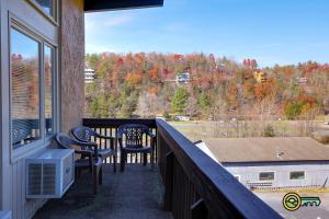 a balcony with two chairs and a view of trees at Aspen East Unit #131 in Basye +13 photos