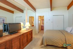 a bedroom with a bed and a flat screen tv at Aspen East Unit #131 in Basye