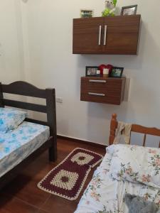 a bedroom with a bed and a dresser on the wall at Esteira in Iguape