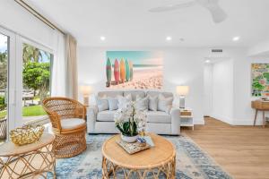 a living room with a couch and a table at The Beach Villa in Juno! 1-Steps to the Beach in Juno Beach