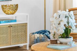 a living room with a table and a plant at The Beach Villa in Juno! 1-Steps to the Beach in Juno Beach