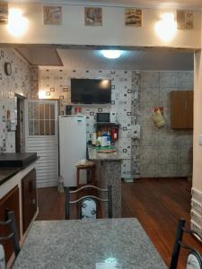 a kitchen with a refrigerator and a counter top at Esteira in Iguape +8 photos