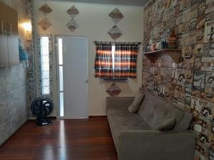 a living room with a couch and a window at Esteira in Iguape