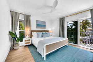 a bedroom with a bed and a large window at ON The Beach Juno! 3-Top Rated Villa! in Juno Beach