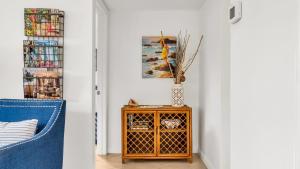 a living room with a blue chair and a table at ON The Beach Juno! Modern Lux Seaside! in Juno Beach