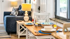 a living room with a table and a blue couch at Juno Beach Seaside Escape I Steps from the Ocean! in Juno Beach