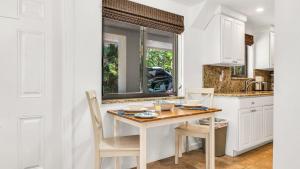 a kitchen with a table and chairs and a sink at Juno Beach Seaside Escape I Steps from the Ocean! in Juno Beach +24 photos