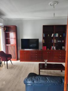 a living room with a couch and a tv at Nicolas Luxury Apartment in Amalias