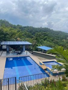 a swimming pool with a view of a mountain at la samara in Anapoima