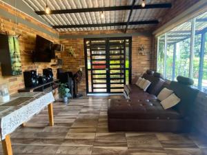 a living room with a couch and a brick wall at la samara in Anapoima