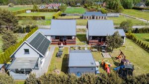 an aerial view of a house with solar panels on it at Domki Anchor - Rodzinne Domki - Cisza i Spokój in Lubiatowo