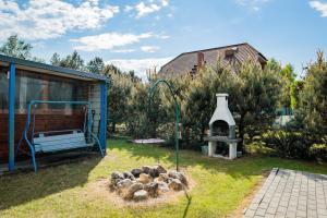 a bunch of animals in a yard with a grill at Domki Anchor - Rodzinne Domki - Cisza i Spokój in Lubiatowo +56 photos