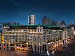 a large building in front of a city at night at Hotel Indigo Harbin Central Avenue by IHG in Harbin