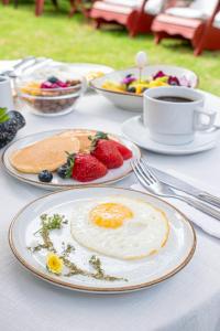 a table with plates of food and a cup of coffee at Casa de Avila Hotel in Arequipa