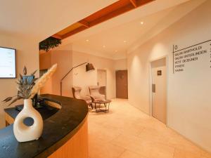 a room with a counter with a vase on it at Mercure Colmar Centre Unterlinden in Colmar +85 photos