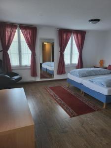 a bedroom with two beds and a mirror at Ambiente in Emmetten in Emmetten