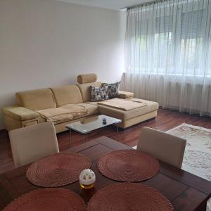 a living room with a couch and a table at Citadella apartman in Pusztavacs