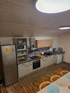 a kitchen with stainless steel appliances and wooden floors at Ambiente in Emmetten in Emmetten +21 photos