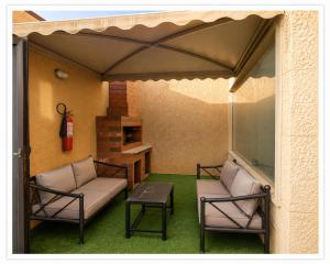 a patio with two chairs and a table and a fire hydrant at شاليهات الفيه in Khamis Mushayt