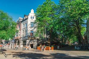 a building on a street with people in front of it at Alex Maastricht in Maastricht
