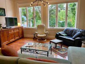 a living room with a couch and a tv at Wisteria Villa in Russell