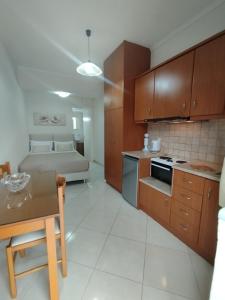 a kitchen with a table and a bed in a room at Georgias House in Lefkada +9 photos